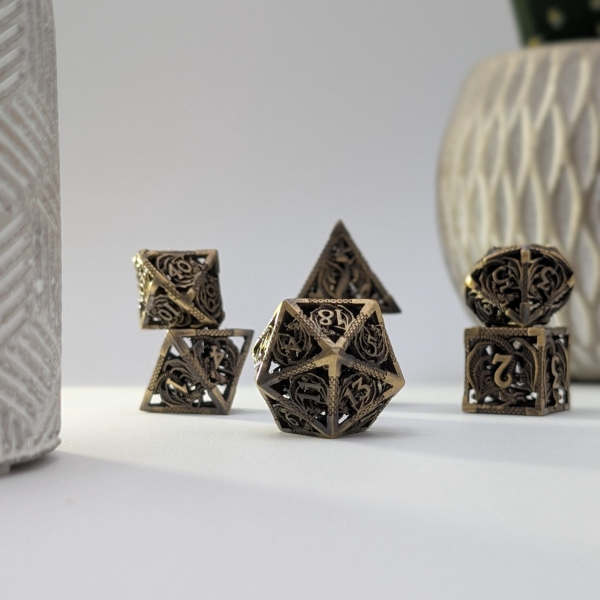 Brass metal dice set with dragon-inspired engravings and musical chimes