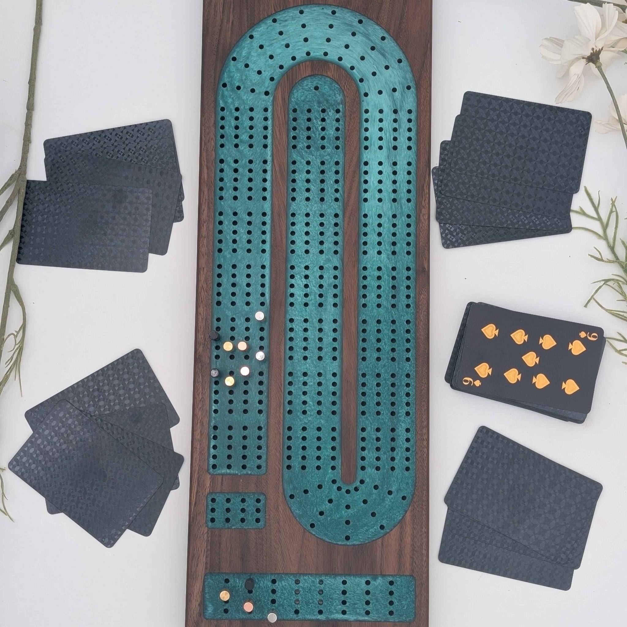 Luxury Walnut Cribbage Board with Emerald Resin Inlay with pegs and cards on white background