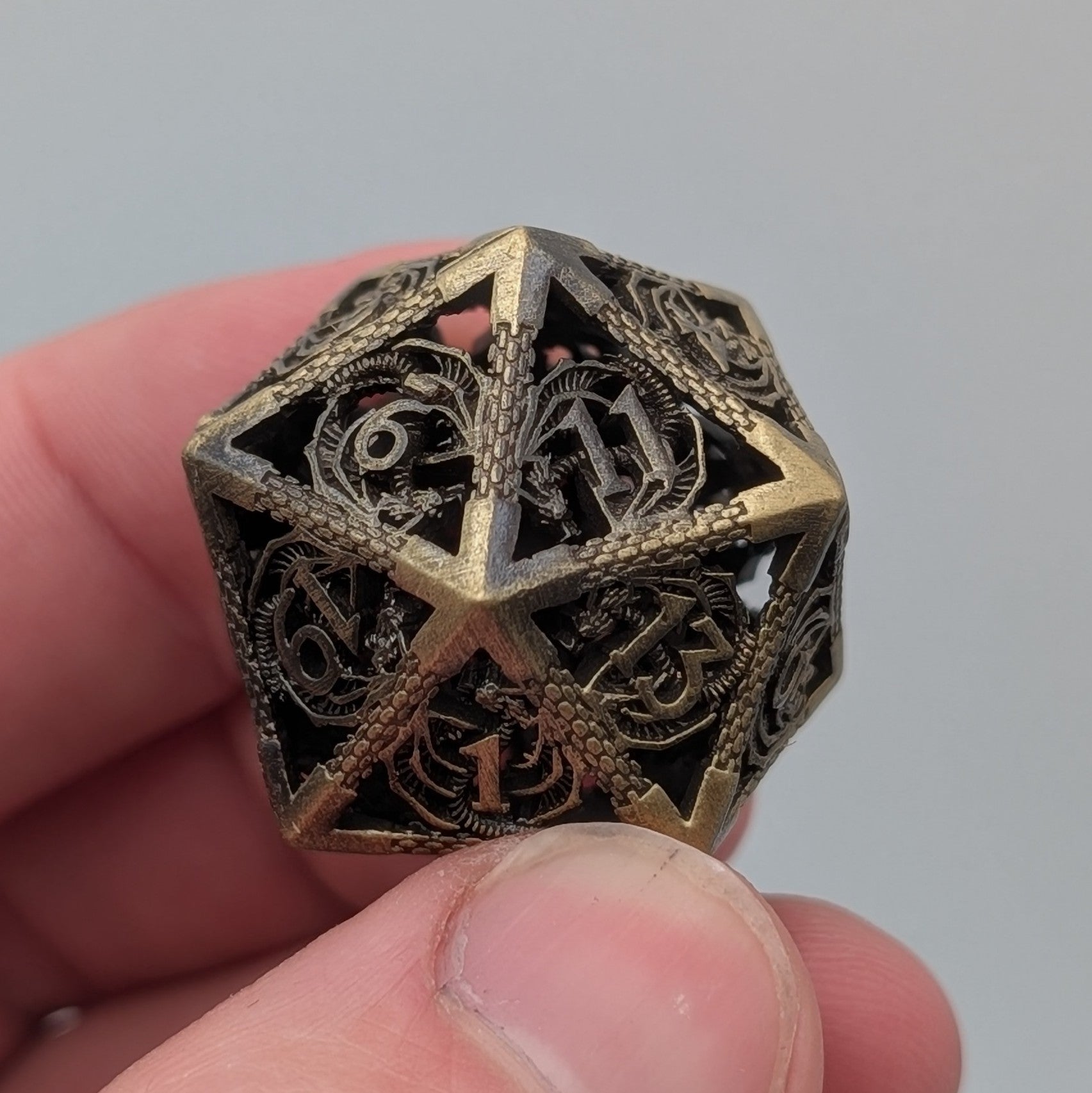 Tarnished brass dragon-engraved chime dice set for DnD and TTRPGs