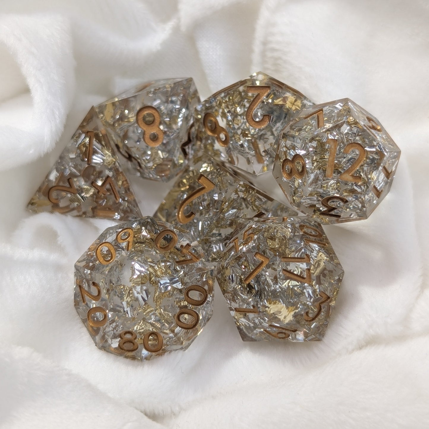 Detailed photo of Emberlight Veil D20 die with foil shimmer and clean inked edges