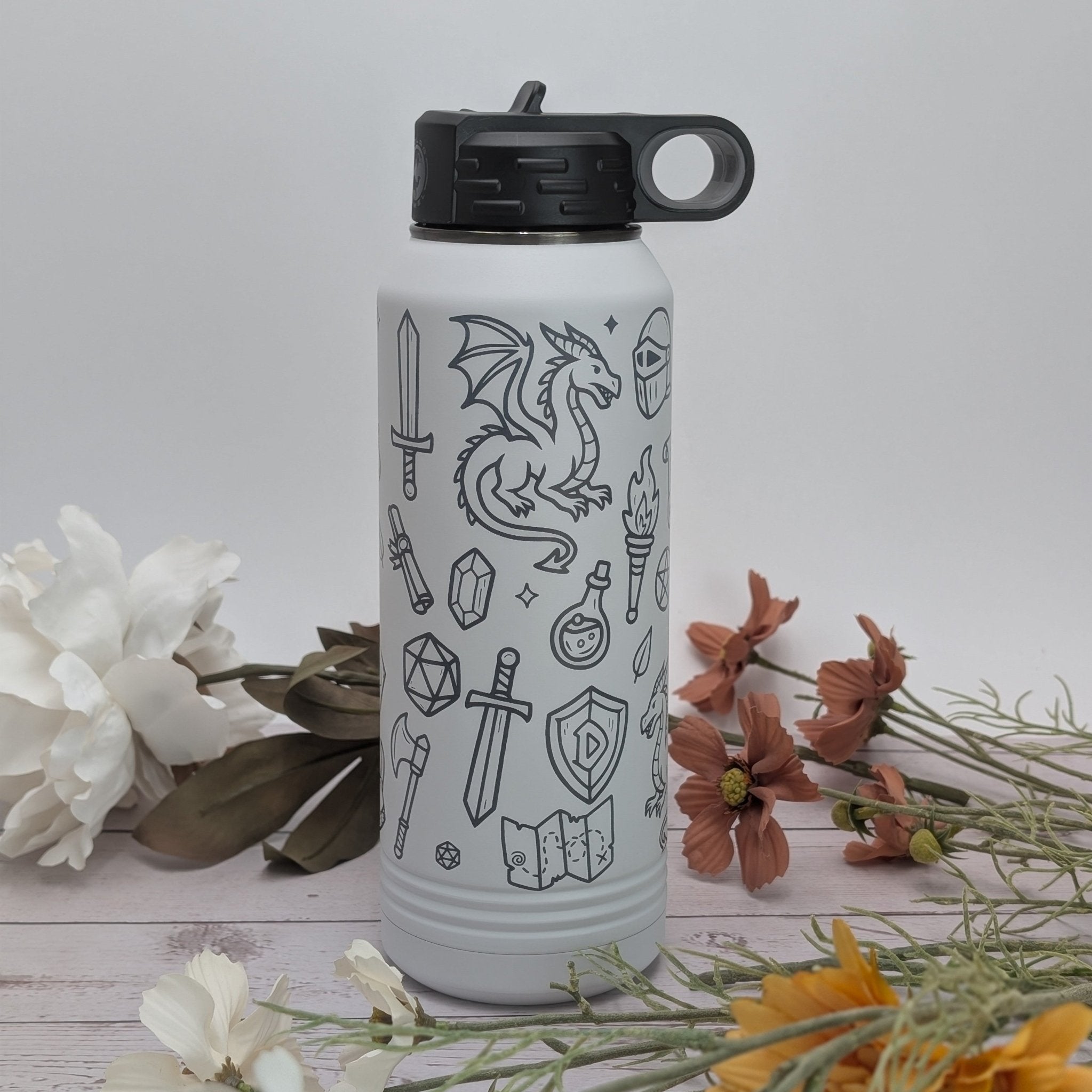 White water bottle with black dragon design surrounded by flowers on a light gray background