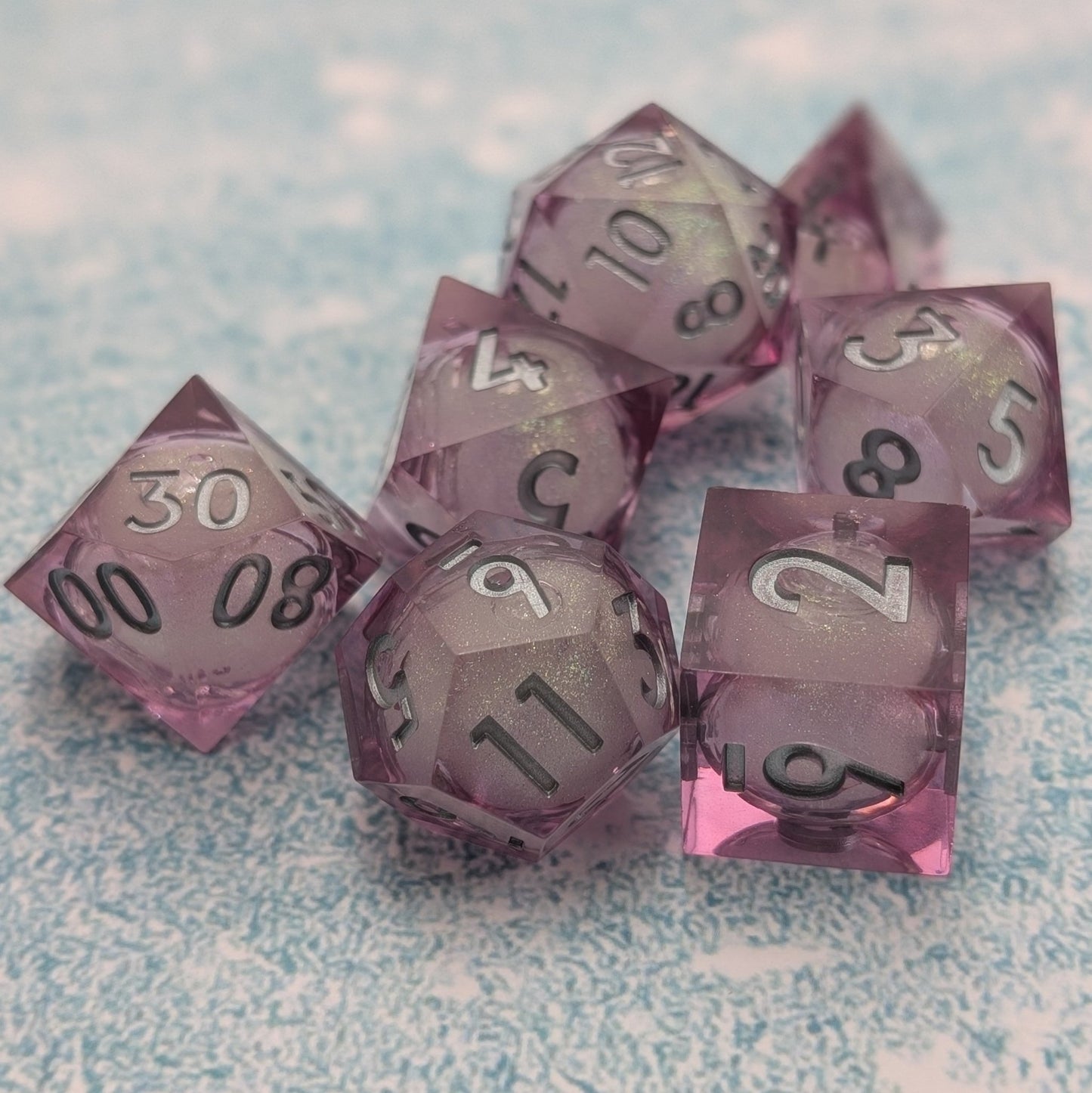 Pink liquid core dice set with sharp edges and silver ink
