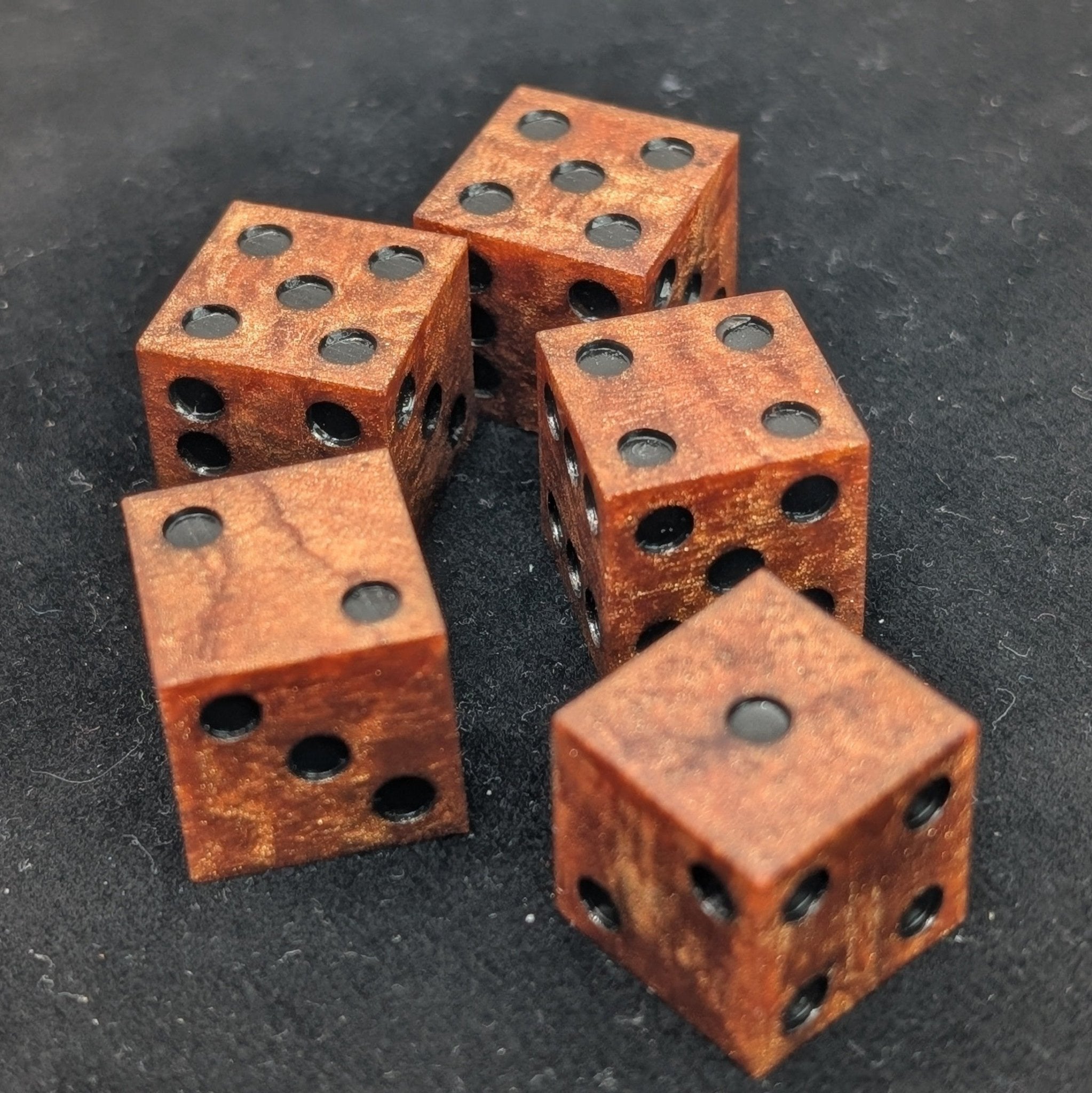 5 d6 copper sharp edge resin casino dice on black background