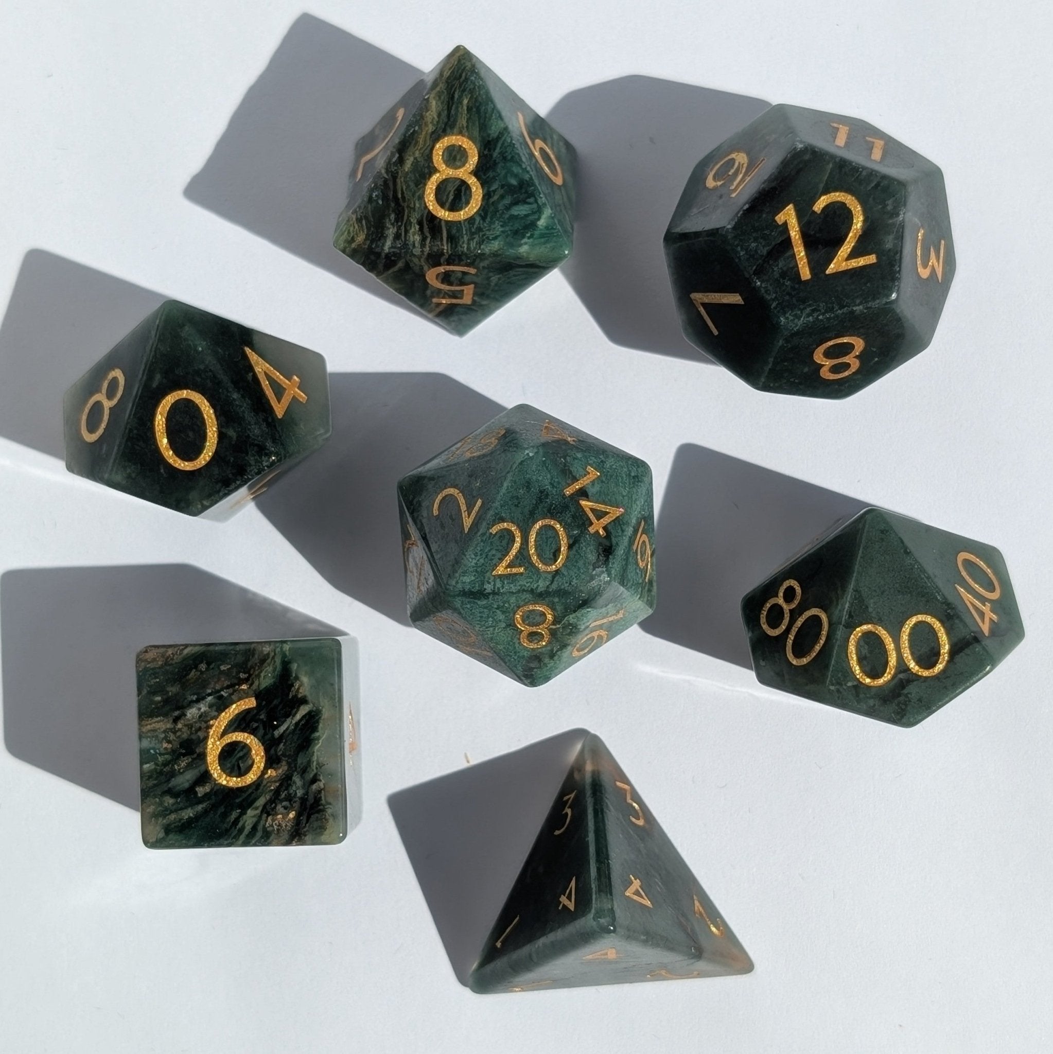 top down image on white background of a african jade green gemstone dice set