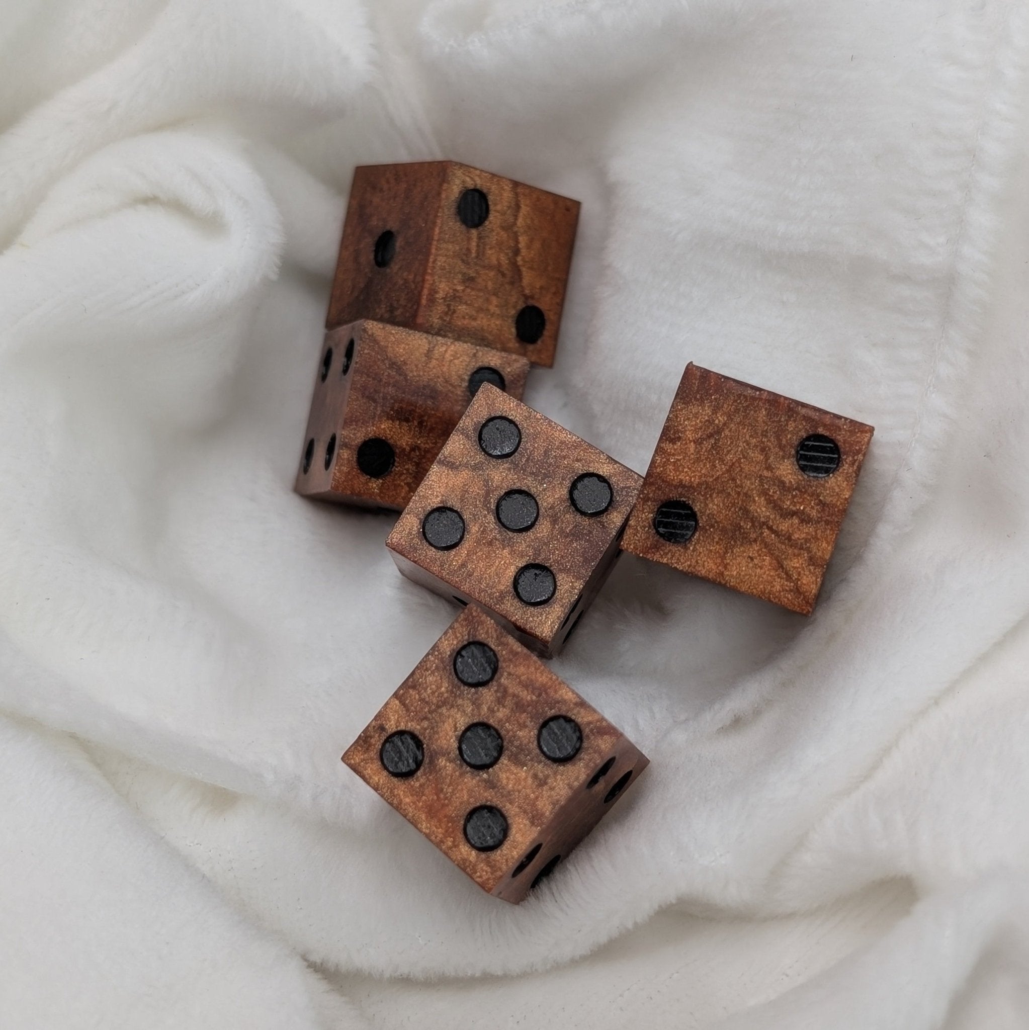 5 d6 copper sharp edge resin casino dice on fluffy white background