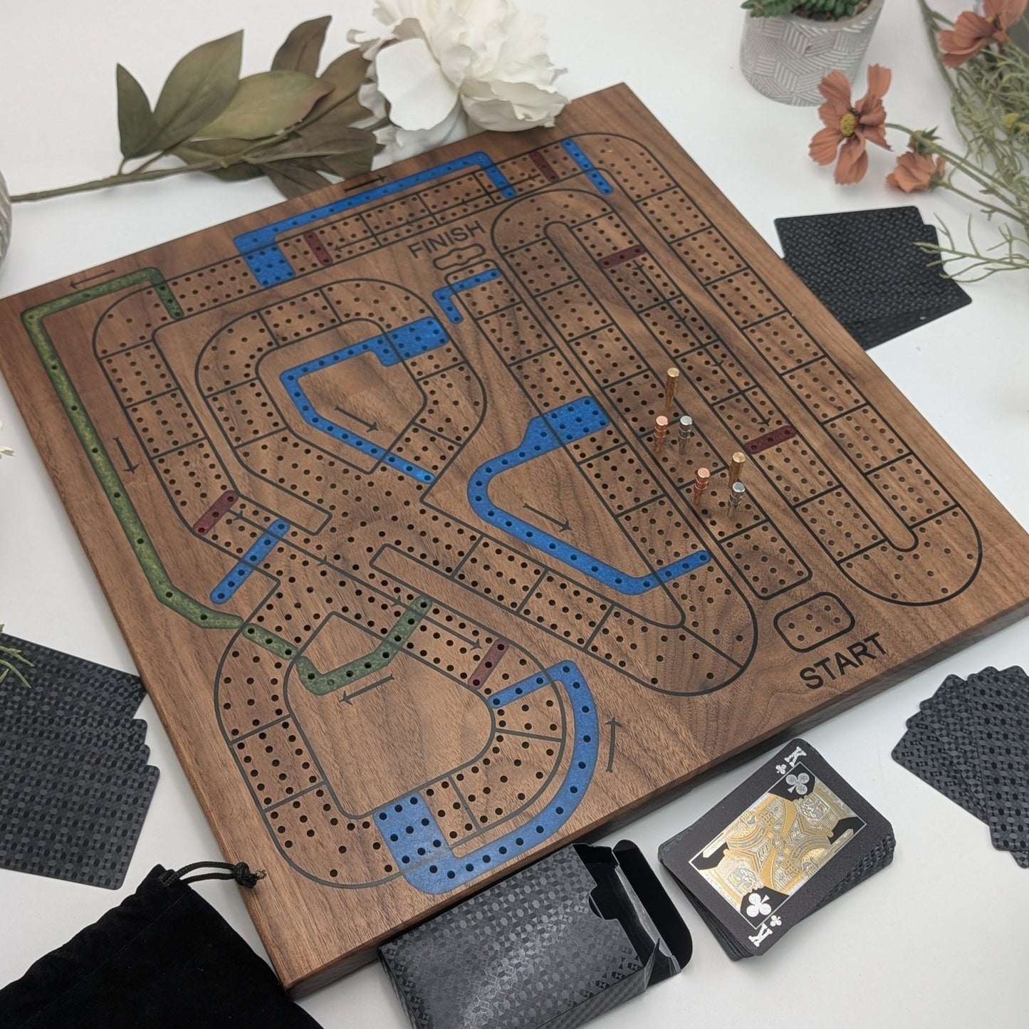 handmade walnut cribbage wars board on white background with cards