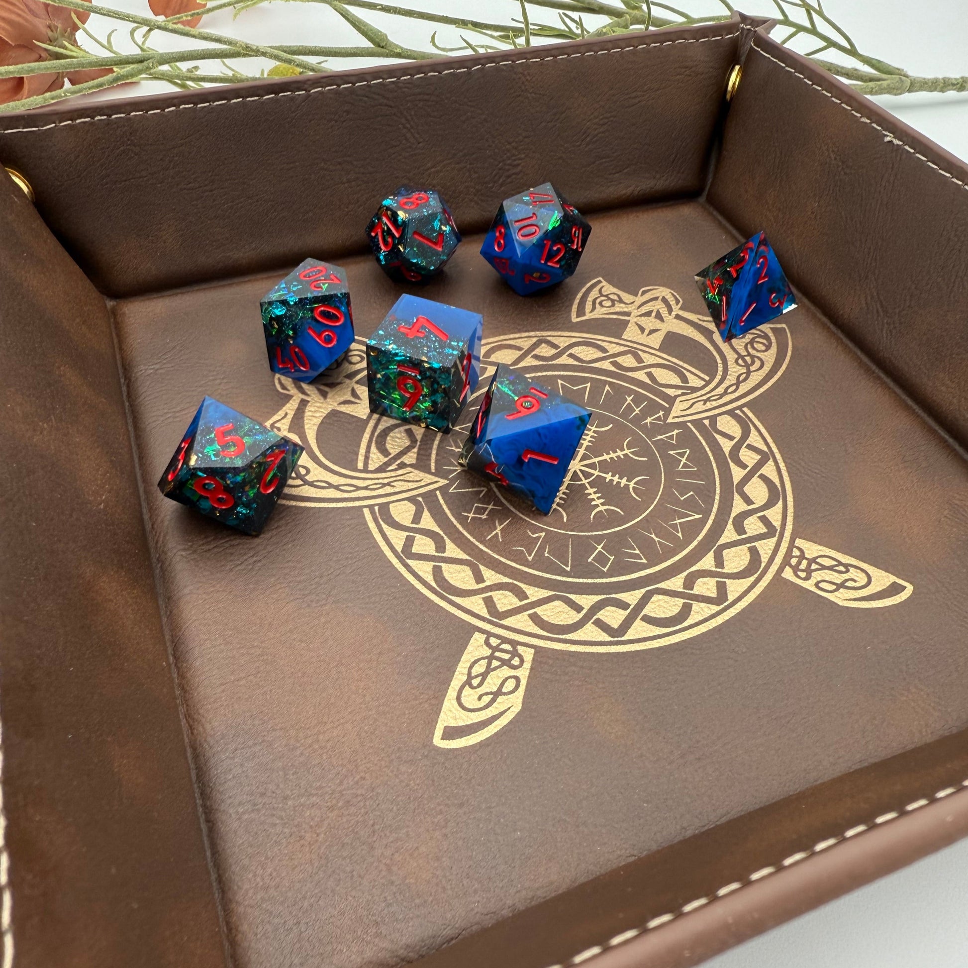 Shot of Blue & Red Polyhedral Dice in Brown Vegan Leather Rolling Tray featuring a crossed axe and runic viking inspired gold engraving