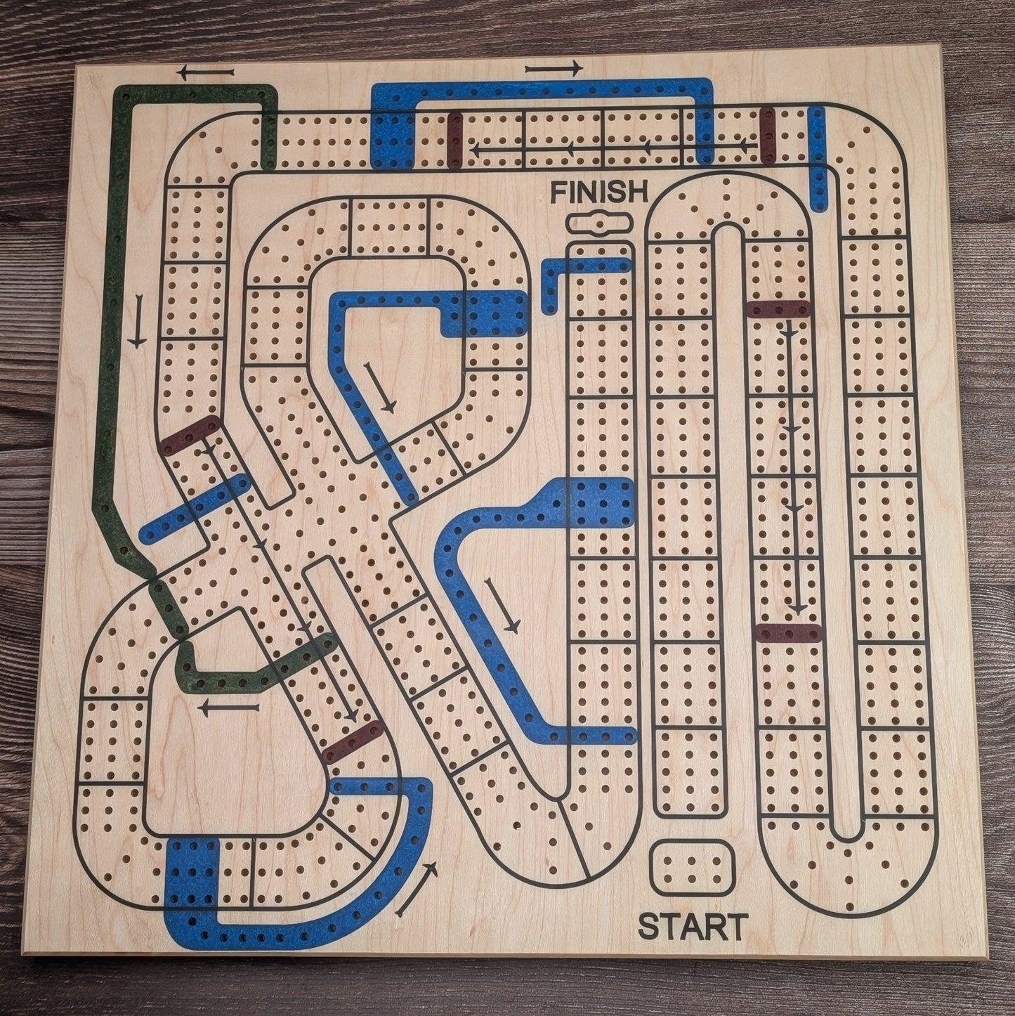 Cribbage Wars Board made with maple wood and epoxy resin inlays on wood grain background