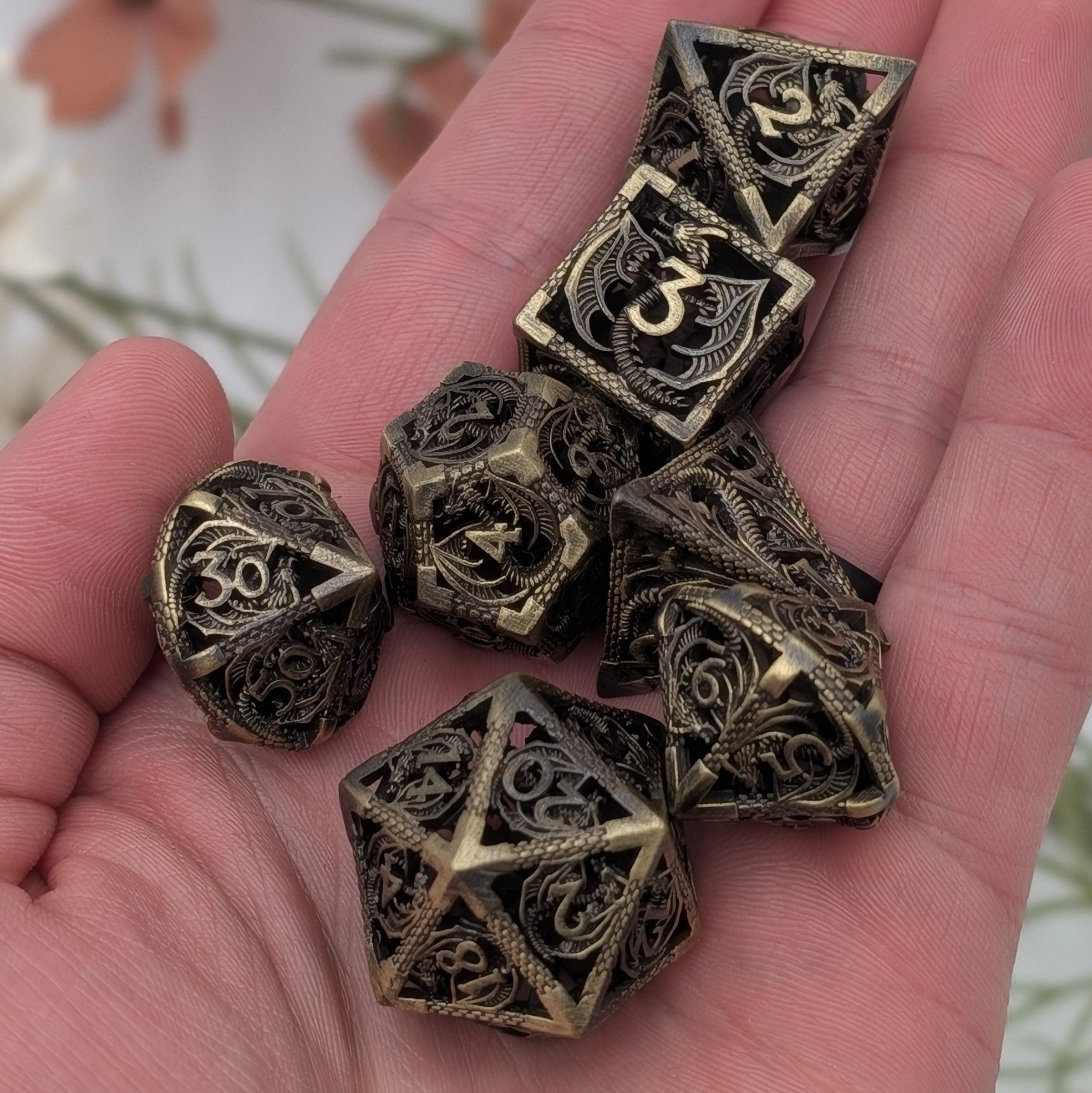 Detailed dragon-themed brass dice with hollow interiors and chime sounds
