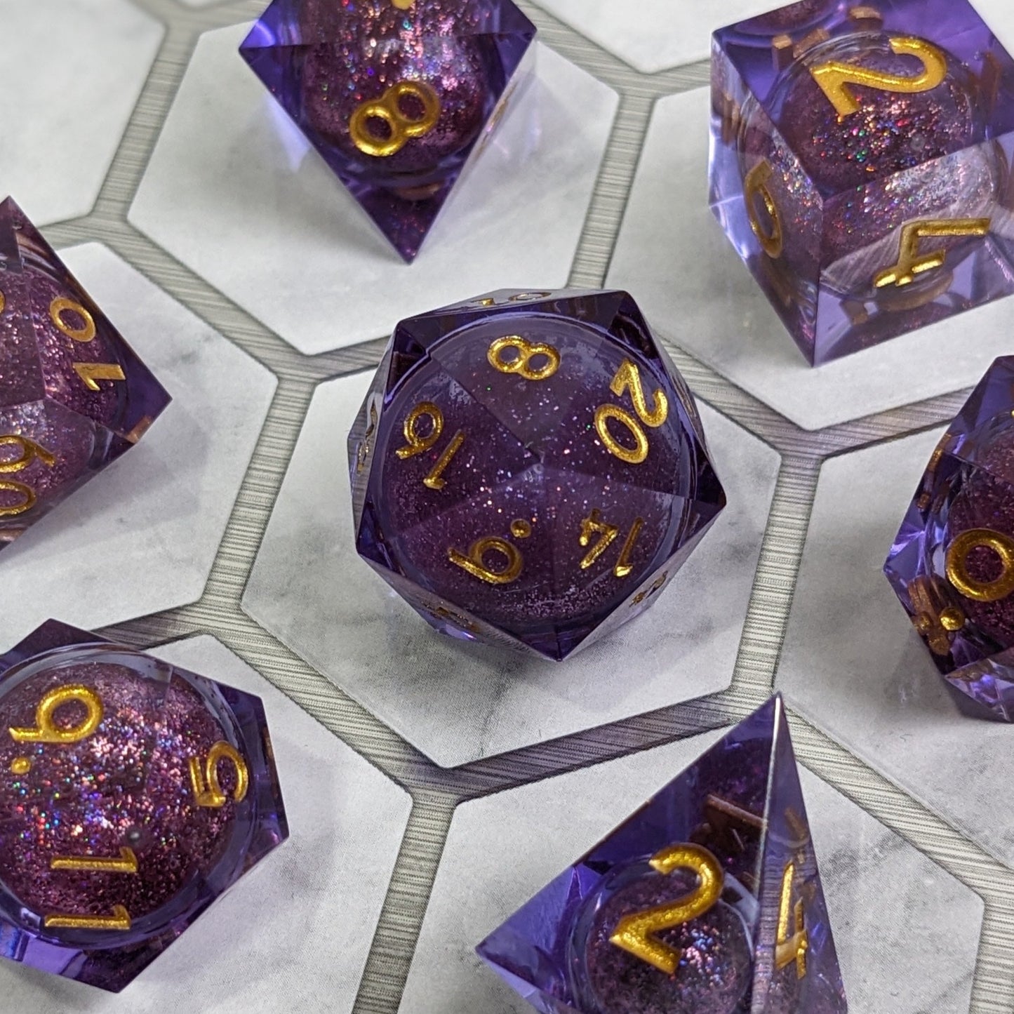 Enchanting Space liquid core dice set on marble like background where each dice is placed within a hexagon shape