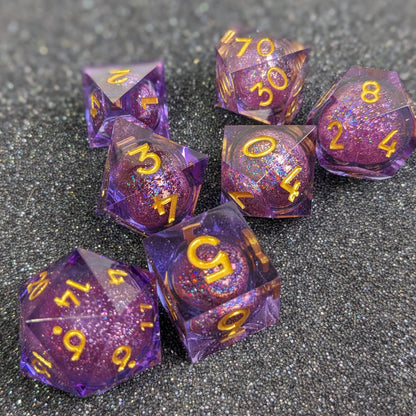 Full 7 set of purple liquid core dice for ttrpgs on a glitter foam base with liquid cores shimmering with glitter effects