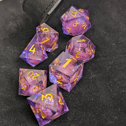 Purple 7 Piece Liquid Core Dice Set with Gold numbers on black background