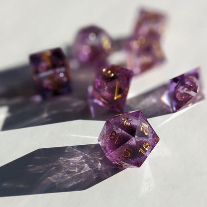 Purple and gold liquid core dice set for dungeons and dragons