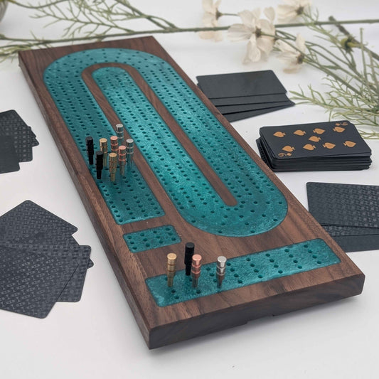 Luxury Walnut Cribbage Board with Emerald Resin Inlay with pegs and cards on white background