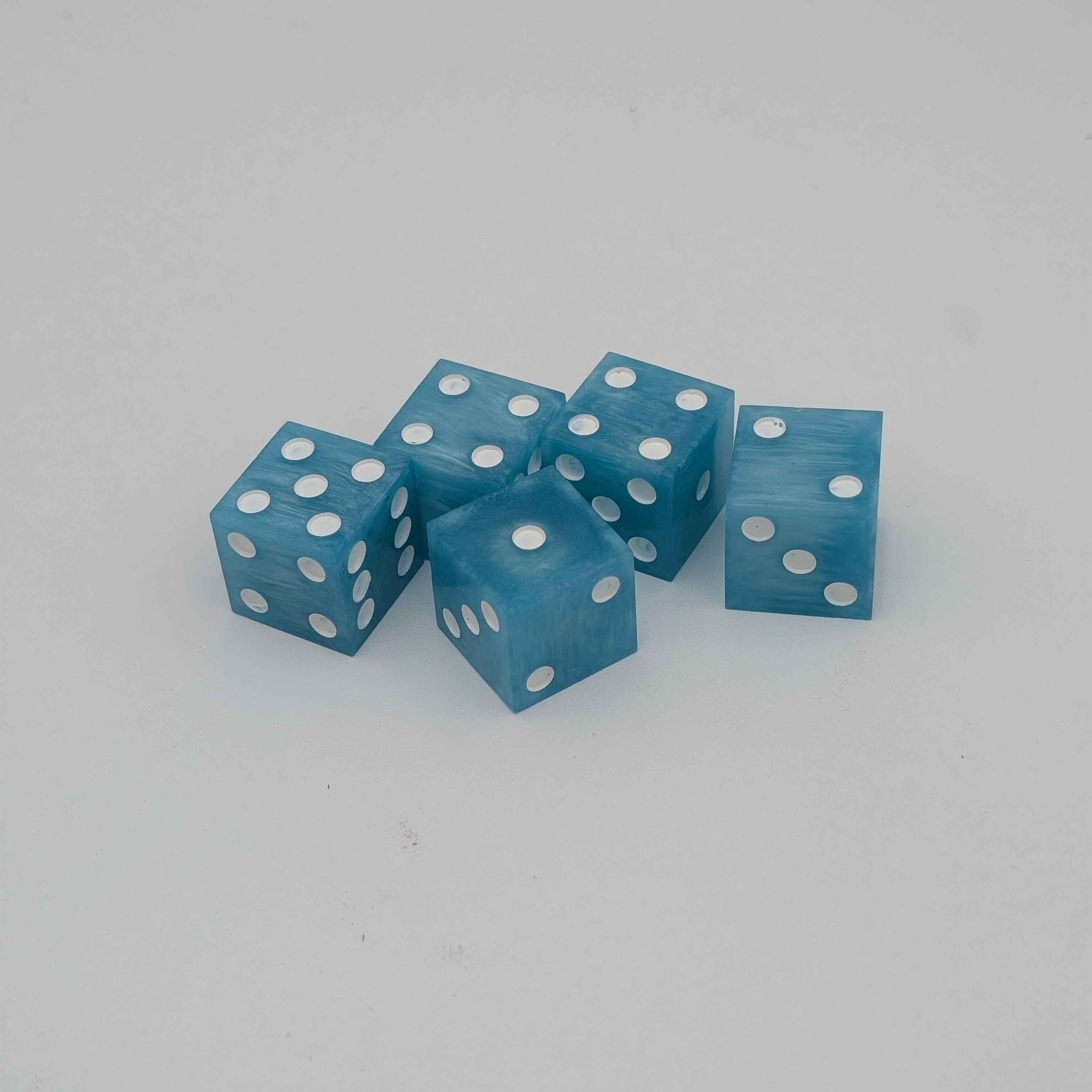 5 Blue and white D6 Dice on a plain white background