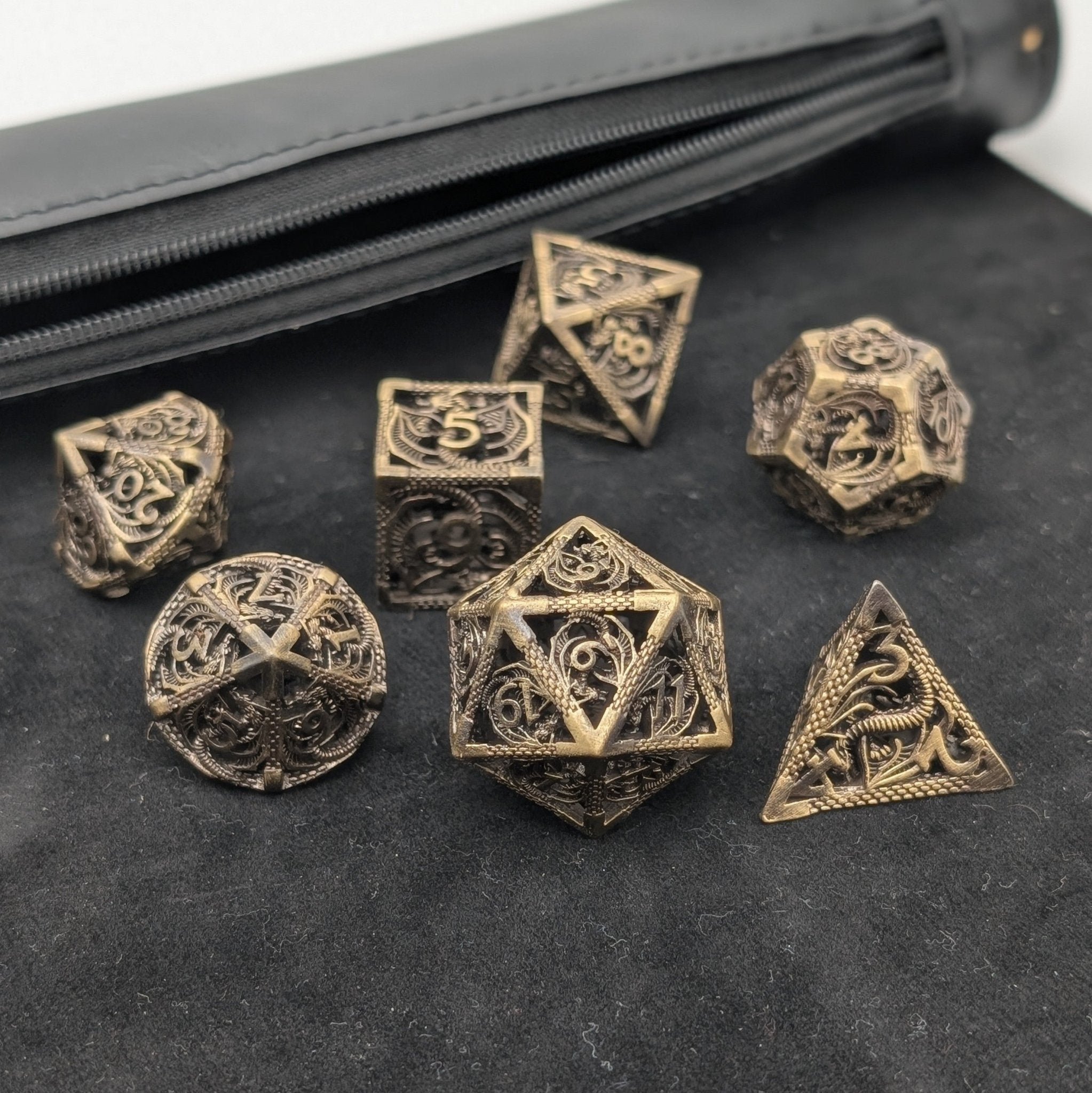 Intricate dragon designs on hollow brass dice that chime when rolled