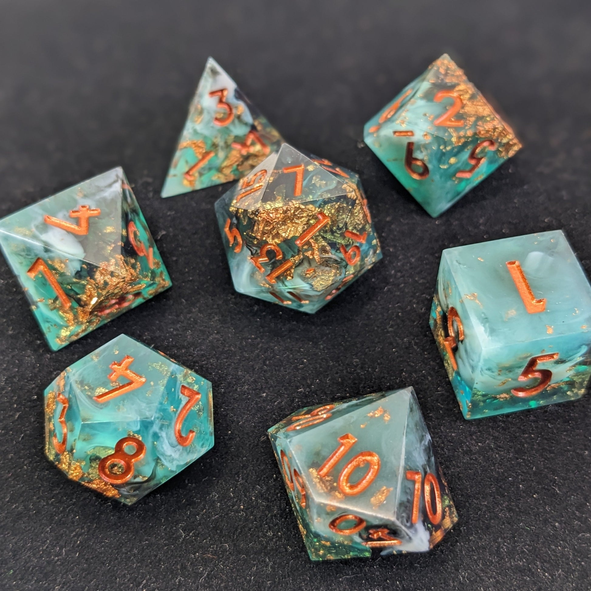 Sharp Edge Resin Dice Set on Black Background with Copper inclusions with Green, White, and Black Resin.