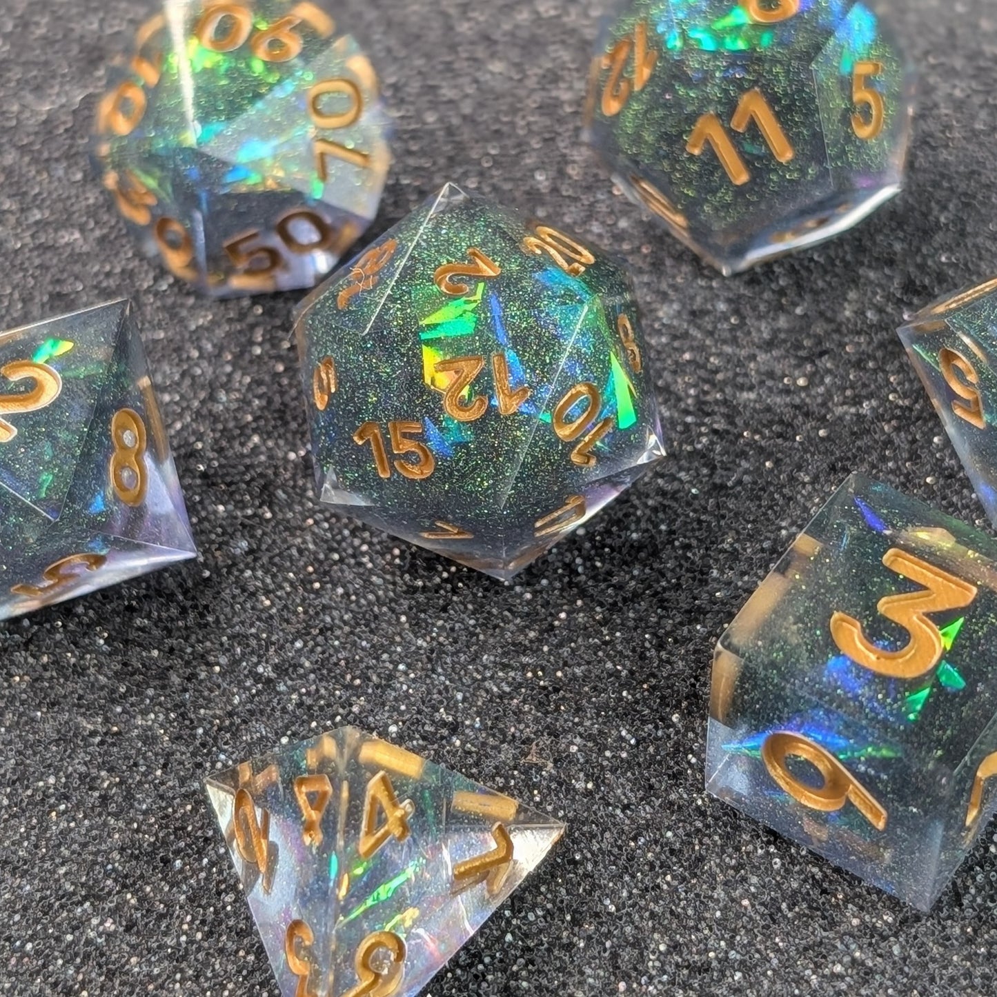 Black and Gold Galaxy Sharp-edged polyhedral dice set on foam table