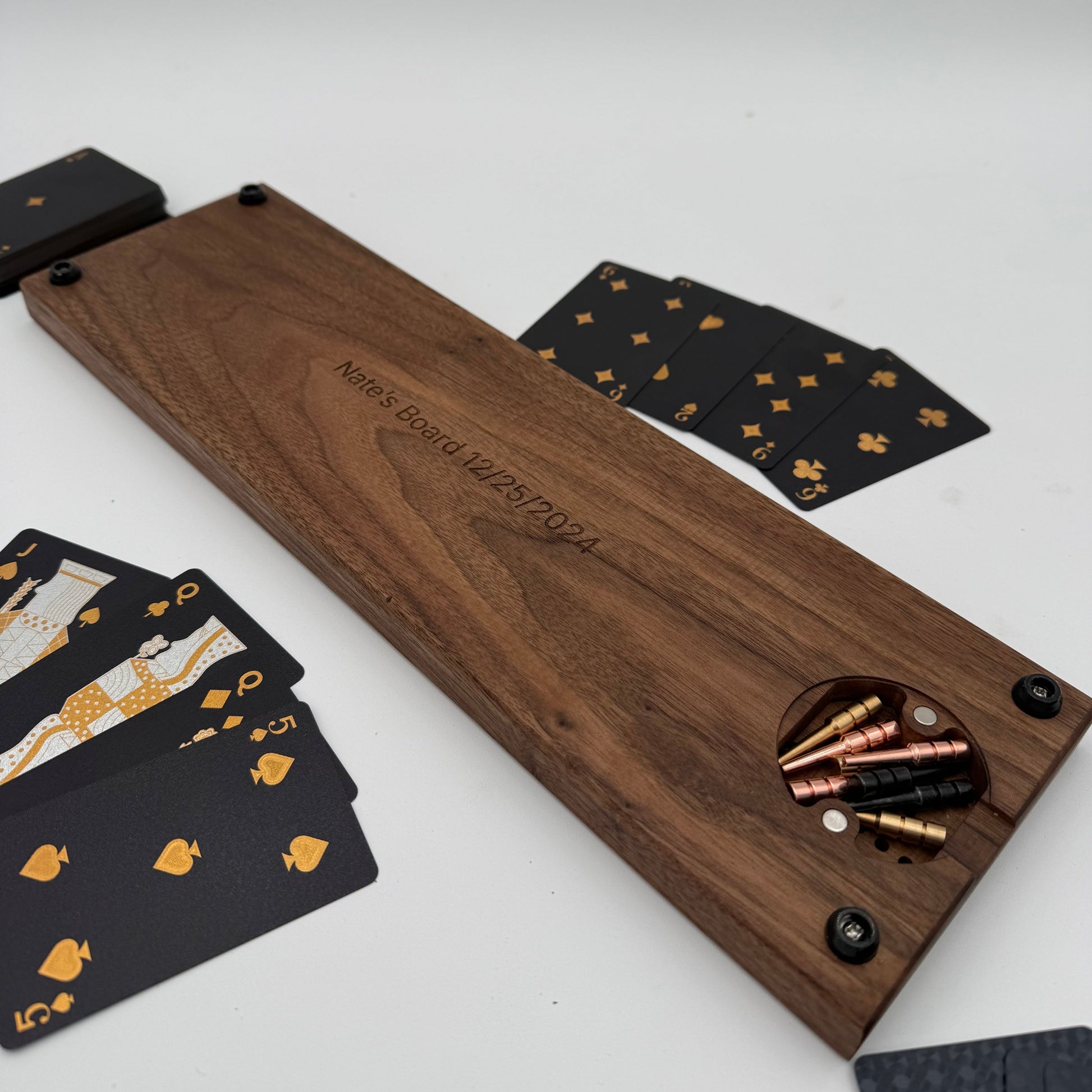 handmade walnut cribbage board with magnetic peg storage showing bottom board with black and gold cards