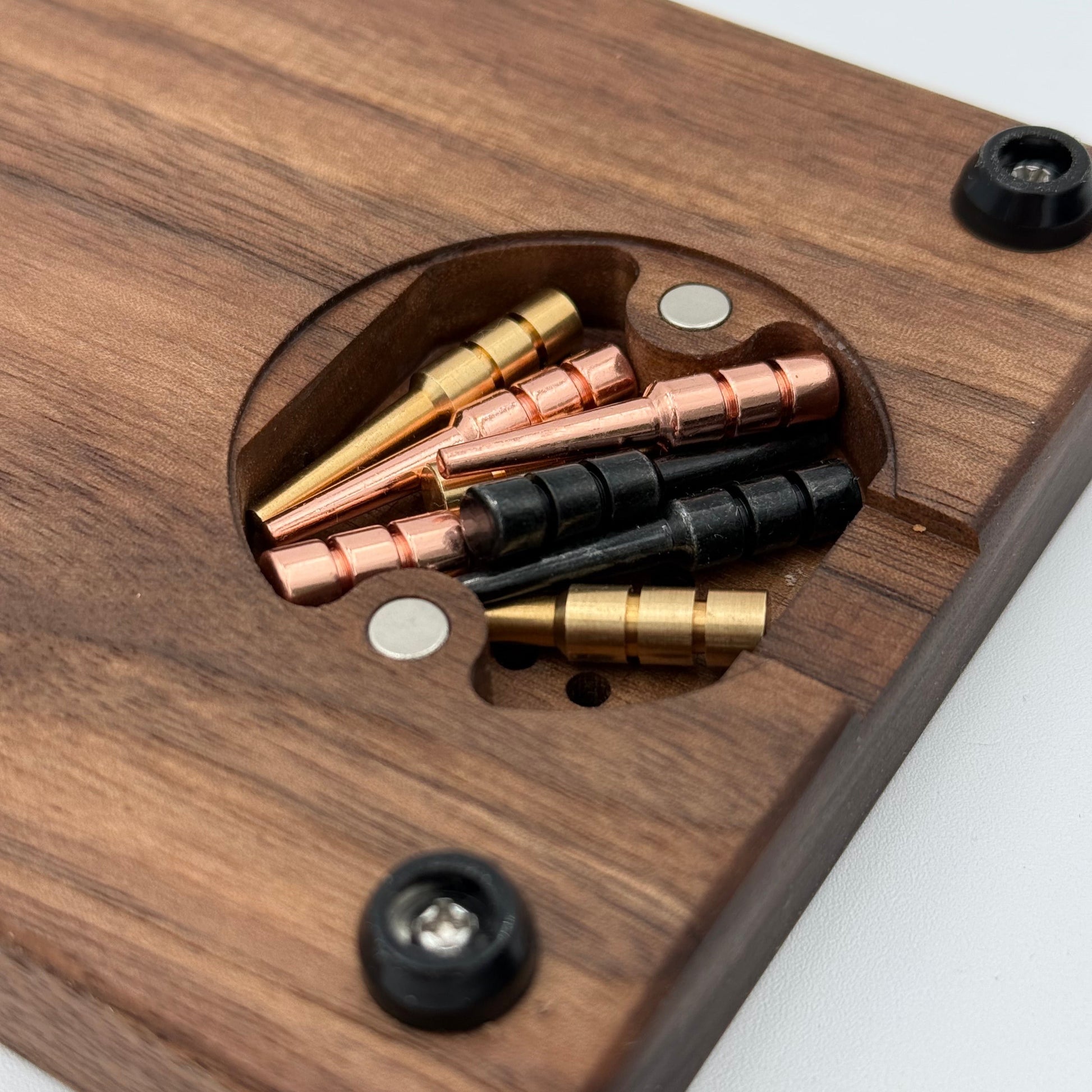 Close up of the magnetic cribbage board peg storage in walnut board with rubber feet showing