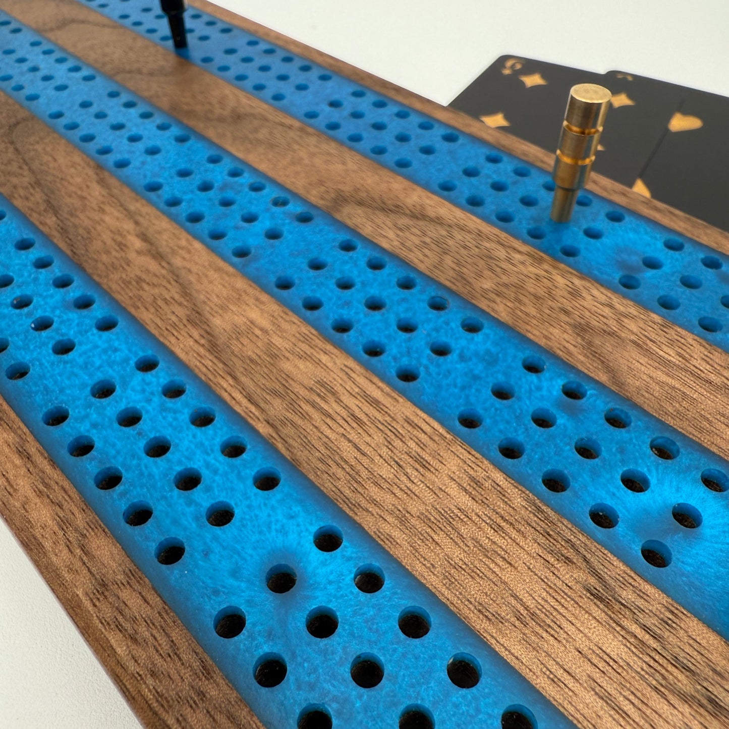 Close up of the walnut and blue inlay cribbage board hadmade showing fine detail of the inlay