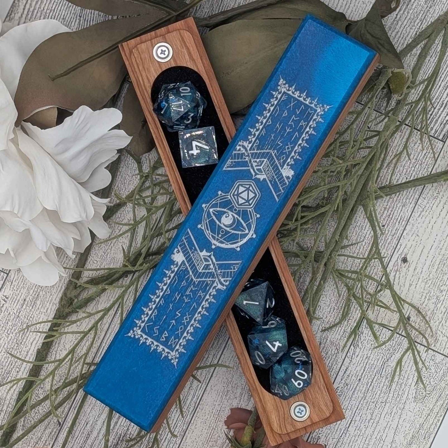 A handcrafted DnD dice vault featuring deep blue resin inlay, engraved with mystical runes and arcane symbols, perfect for tabletop RPGs.
