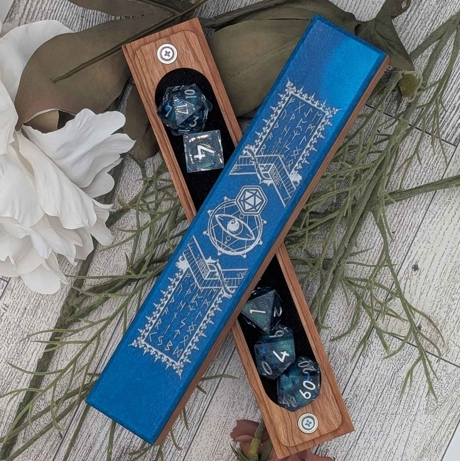 A handcrafted DnD dice vault featuring deep blue resin inlay, engraved with mystical runes and arcane symbols, perfect for tabletop RPGs.