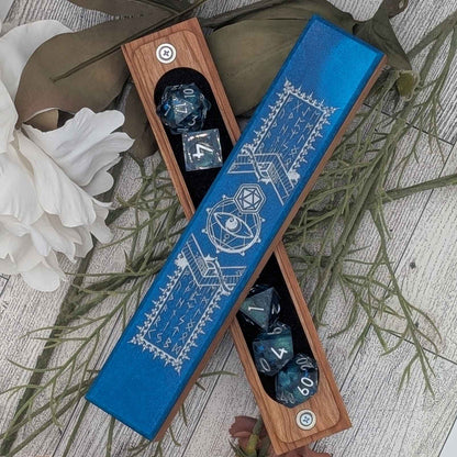A handcrafted DnD dice vault featuring deep blue resin inlay, engraved with mystical runes and arcane symbols, perfect for tabletop RPGs.