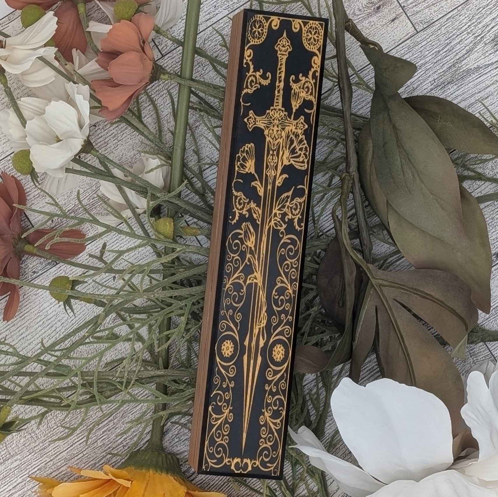 Engraved wooden dice vault featuring a sword design, customizable resin color, and paint infill.