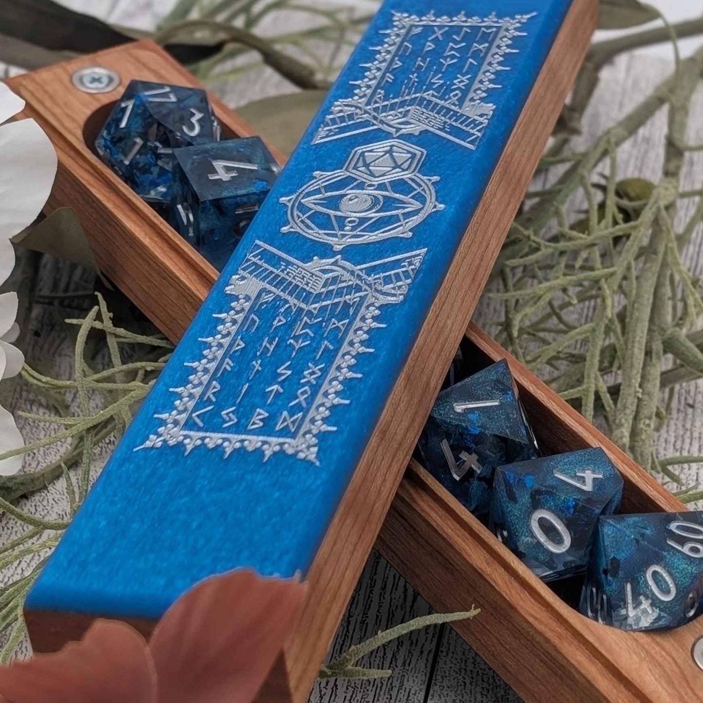 Close-up of an engraved RPG dice vault with shimmering resin inlay, designed for tabletop role-playing games like Dungeons & Dragons.