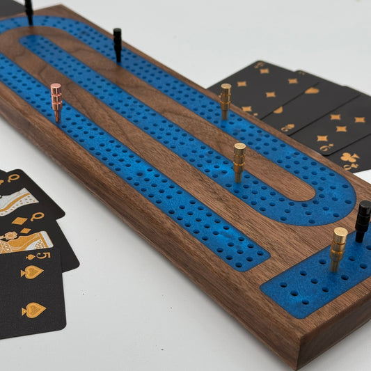handmade 3 player walnut cribbage board with blue resin inlay side shot