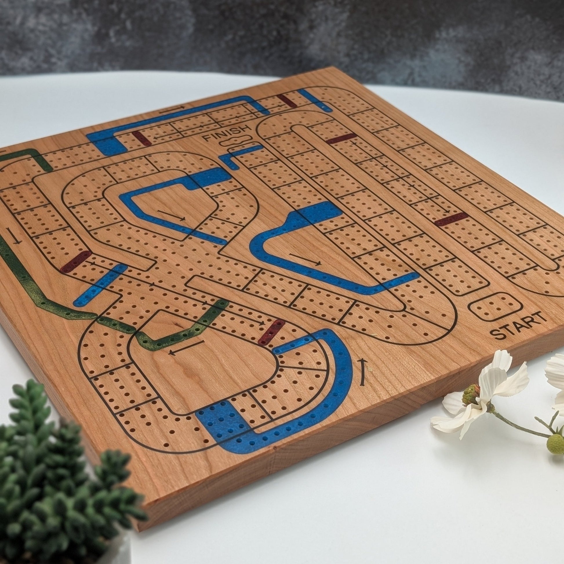 handmade cribbage wars board on white background with flowers and a black blackdrop