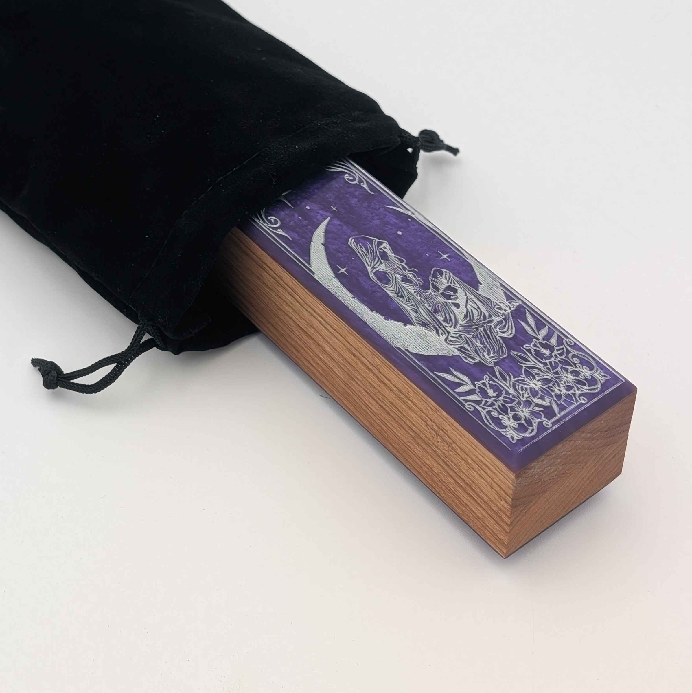Close-up detail of the Lunar Whispers dice vault, showcasing intricate silver celestial artwork hidden in its velvet bag that comes with each purchase.