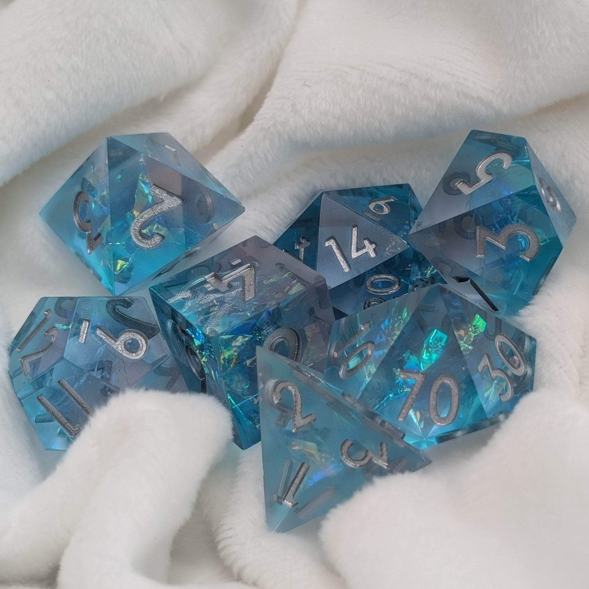 Oceanheart Opals full 7-piece D&D dice set on display with shimmering blue resin
