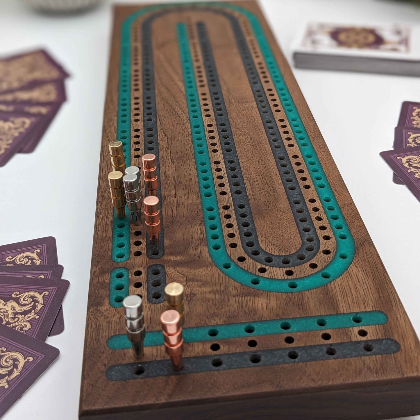 luxury walnut cribbage board with emerald green and onyx grey resin inlay