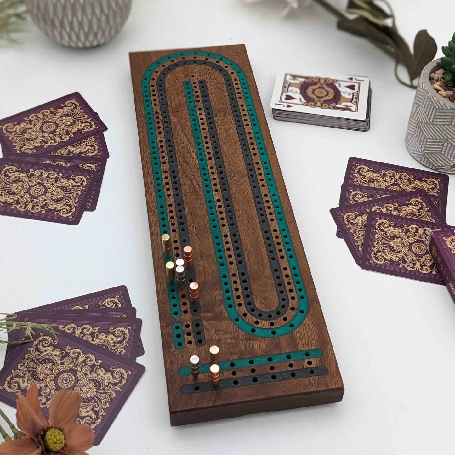 luxury walnut cribbage board with emerald green and onyx grey resin inlay