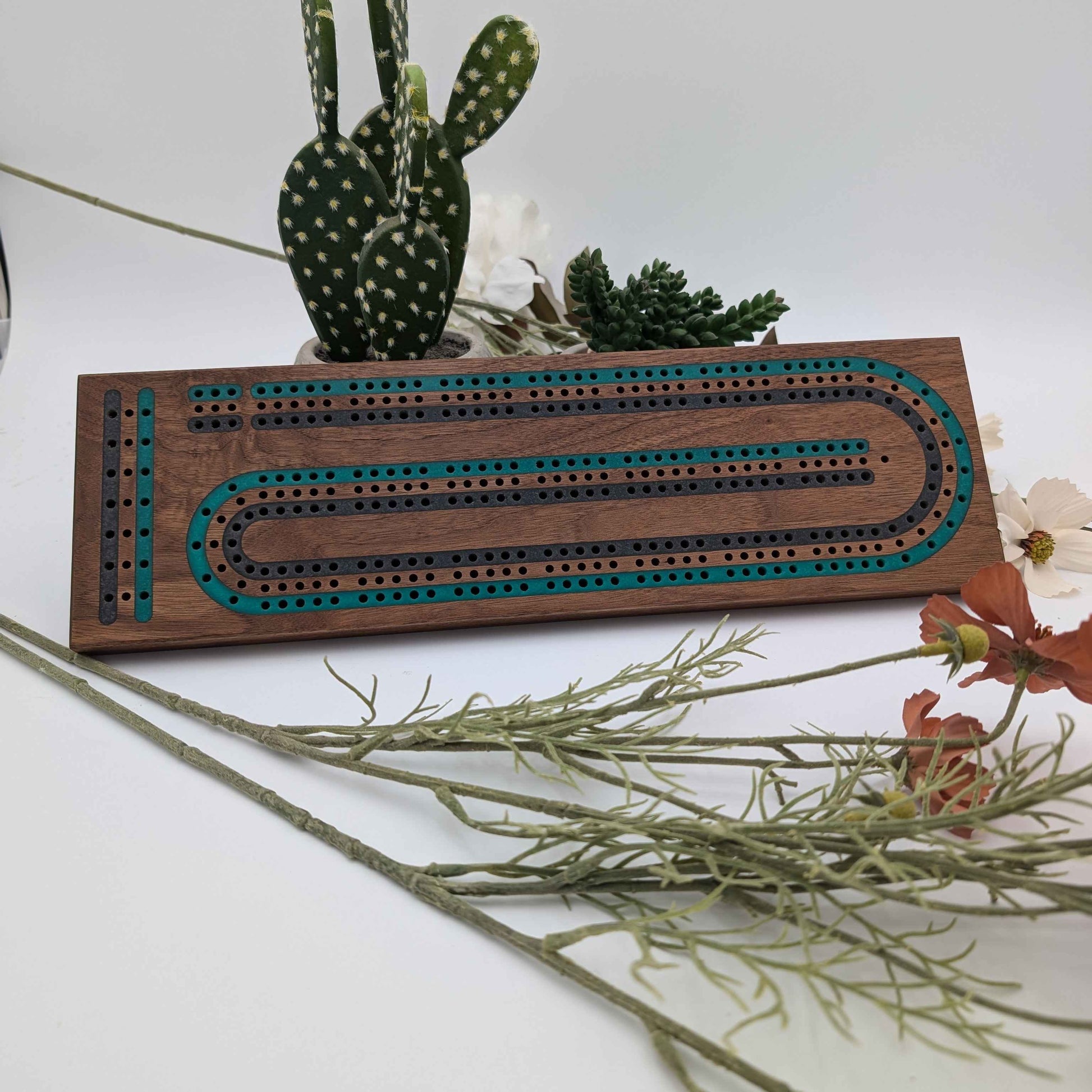 luxury walnut cribbage board with emerald green and onyx grey resin inlay