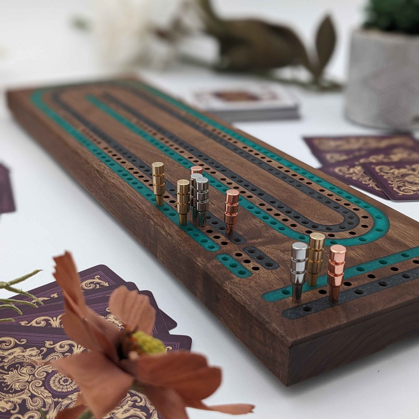 luxury walnut cribbage board with emerald green and onyx grey resin inlay