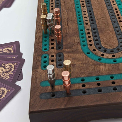 luxury walnut cribbage board with emerald green and onyx grey resin inlay