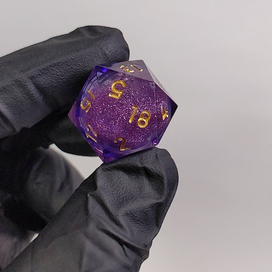 Purple and Gold Liquid Core D20 shaken to show off the liquid core.