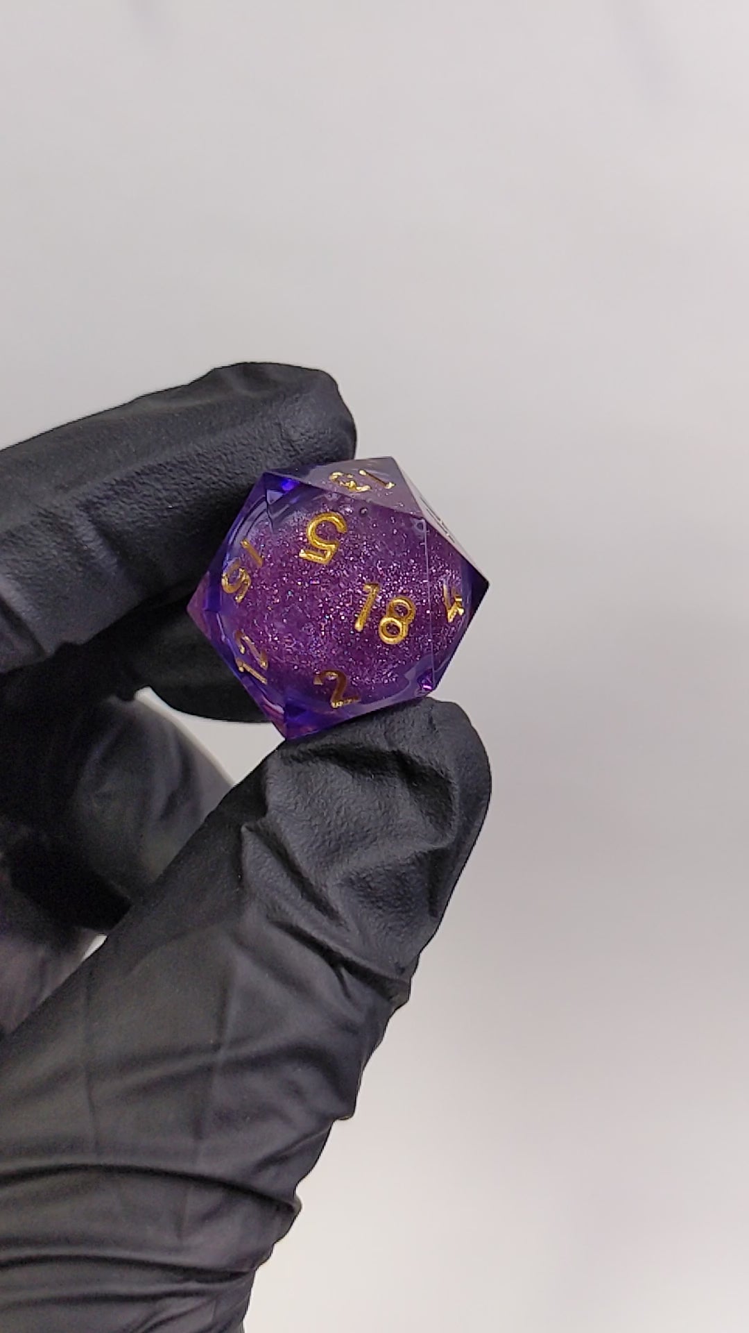 Purple and Gold Liquid Core D20 shaken to show off the liquid core.