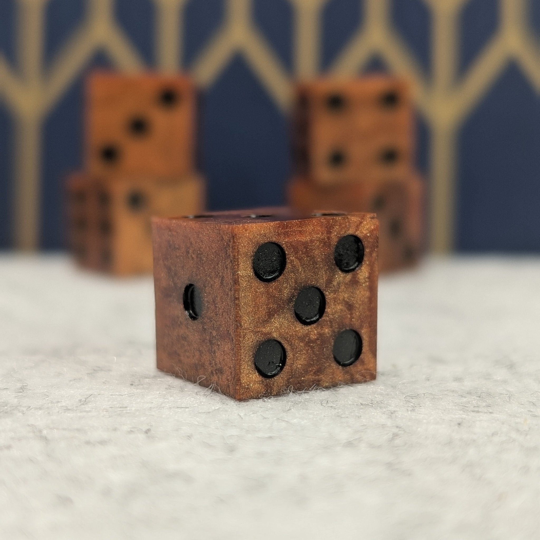 copper d6 dice set with black pips on white and blue background