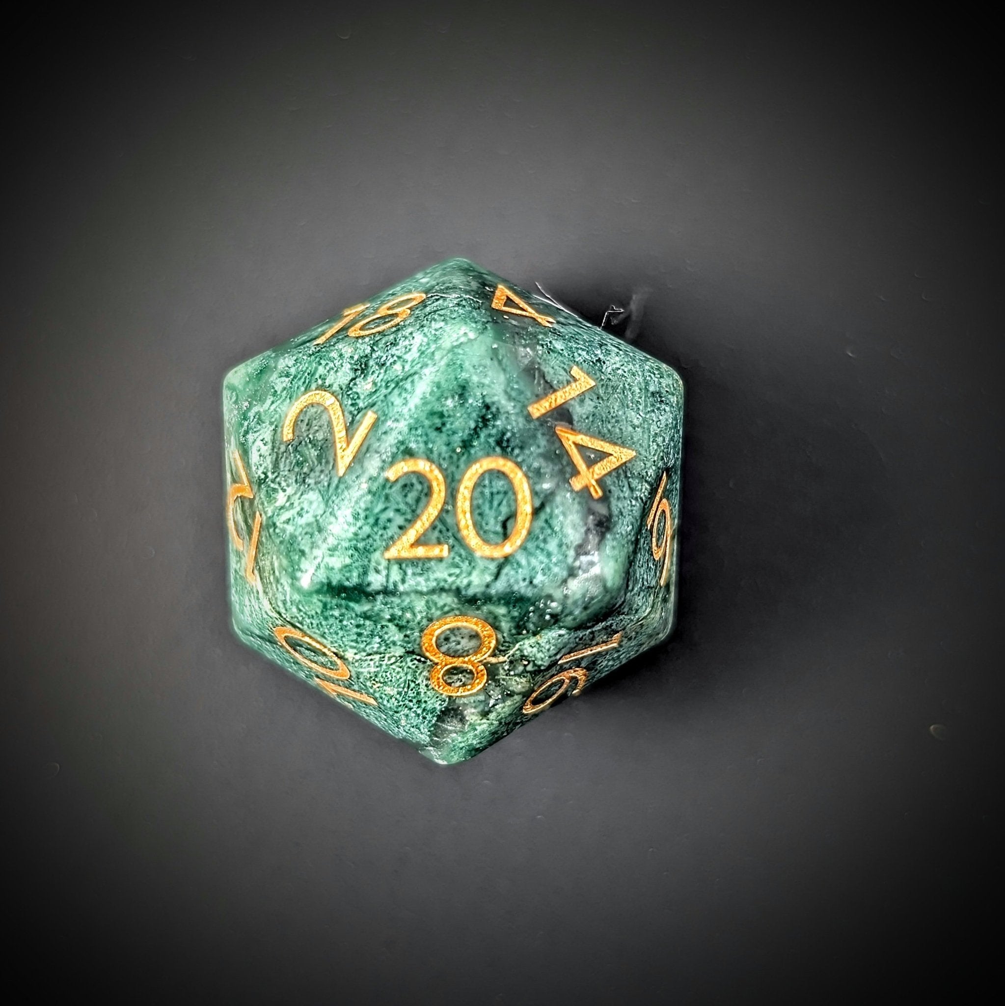 green african jade d20 on grey background