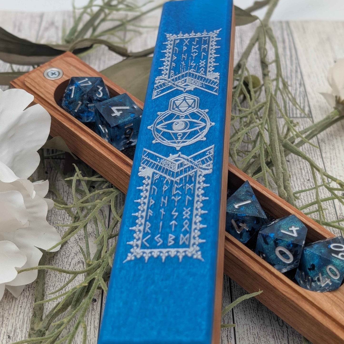 A premium TTRPG dice storage case made of hardwood and resin, engraved with magical symbols for a unique tabletop gaming accessory.