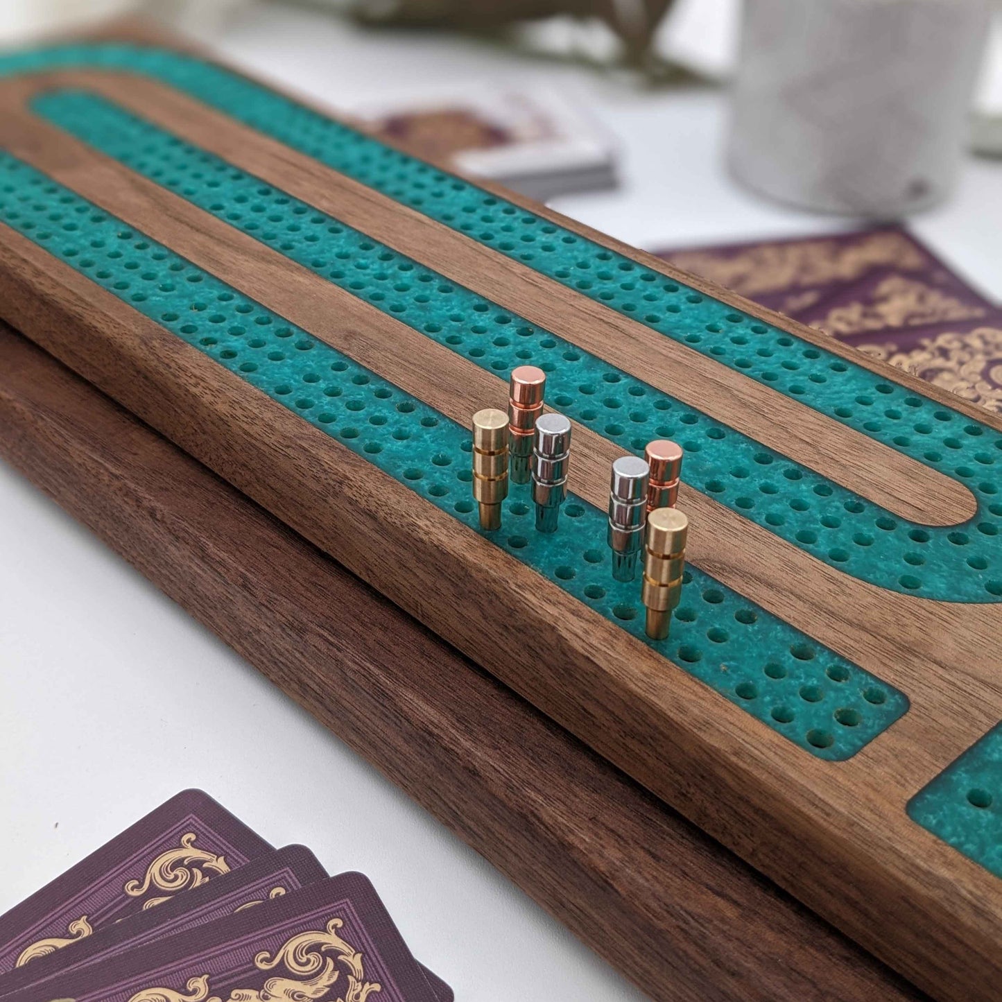 handmade walnut cribbage board with emerald epoxy resin inlay with card and page storage