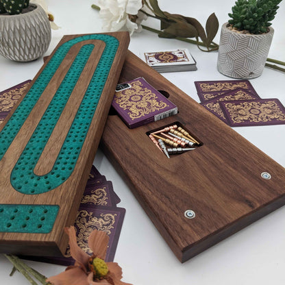 handmade walnut cribbage board with emerald epoxy resin inlay showing card storage